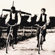 Very old photo of two carpenters on a bicycle