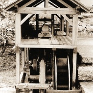 Old photo of a model waterwheel and sawmill