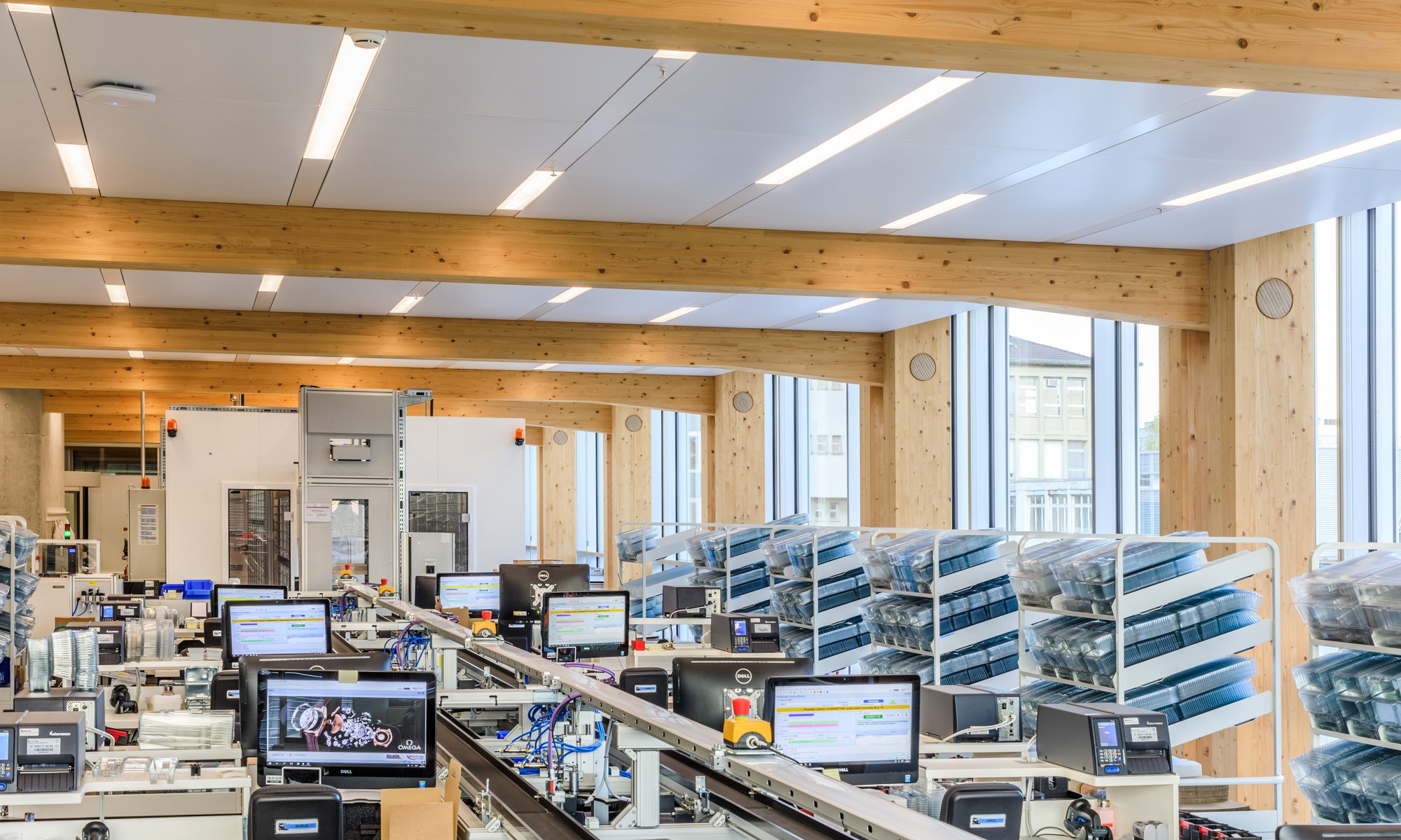 Photograph of the Omega production workshop with timber roof structure and bright, open spaces
