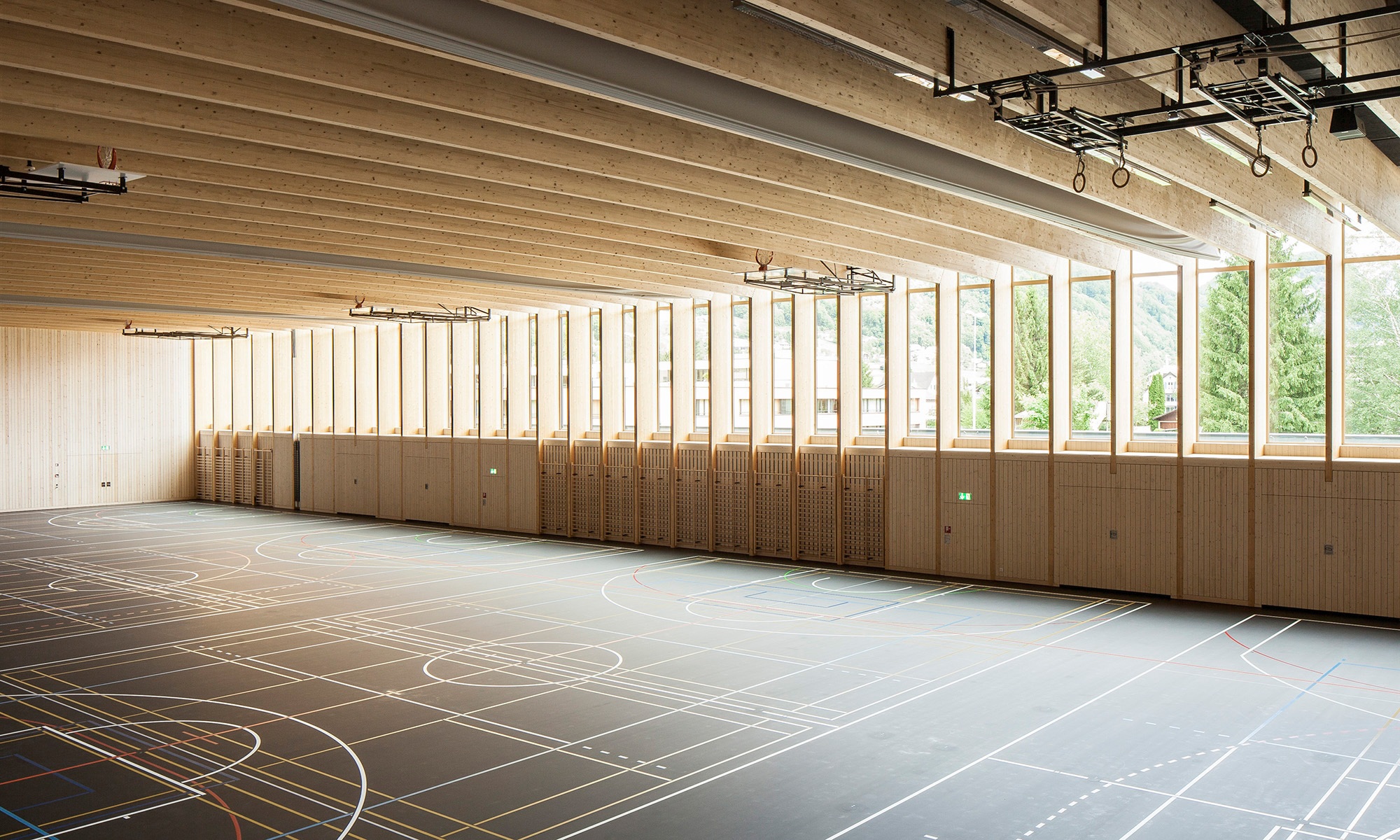 The photograph shows the wooden wall and ceiling structure in the Sargans sports hall