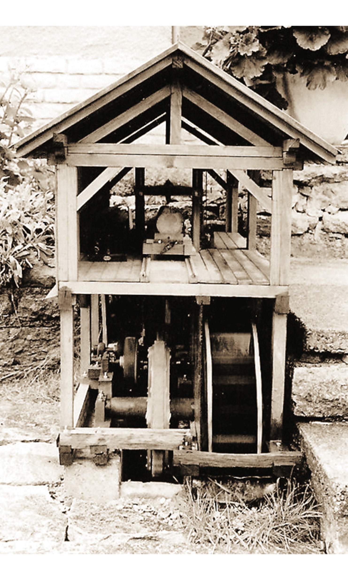 Old photo of a model waterwheel and sawmill