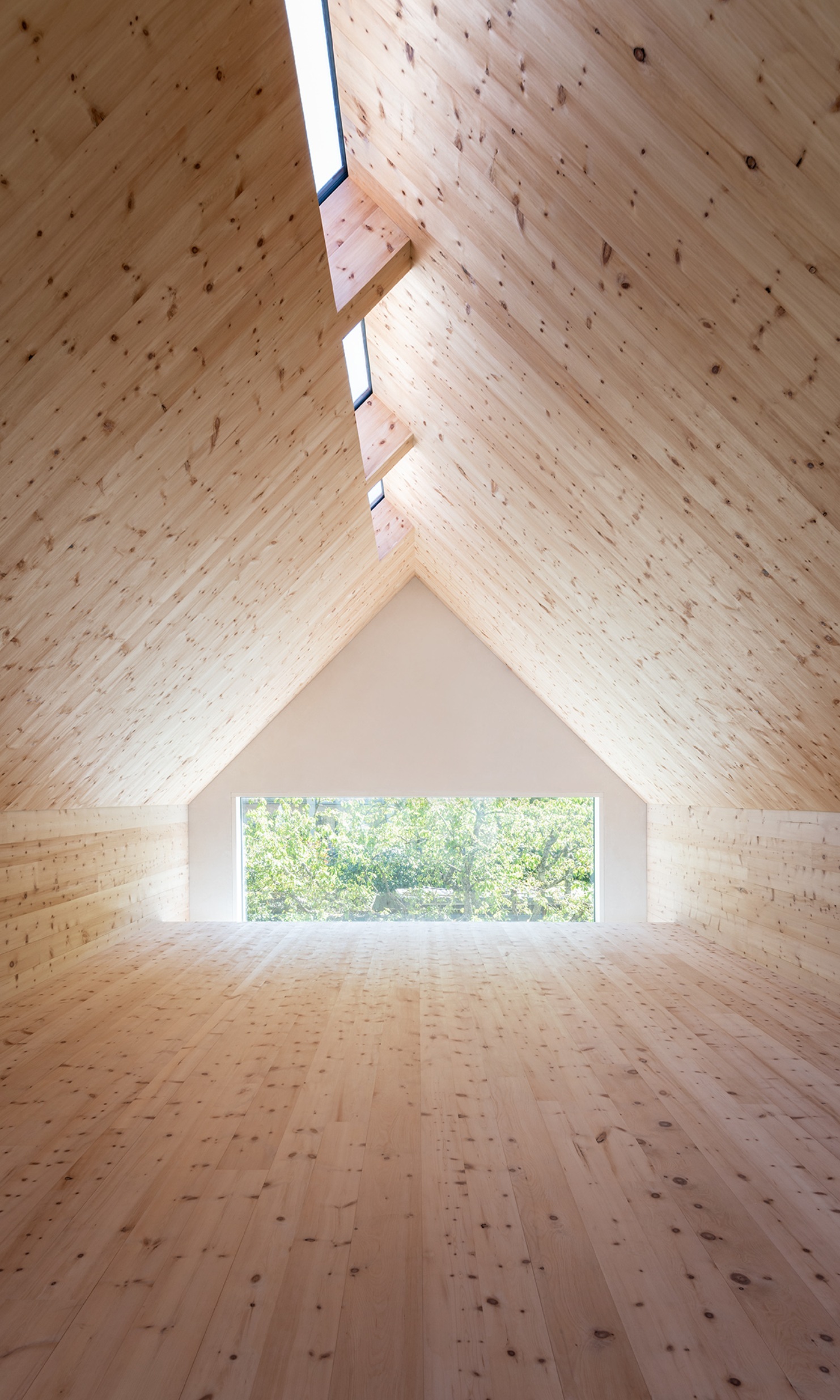 A space clad entirely in Swiss pine with lots of natural light on the top floor of Sutra House.