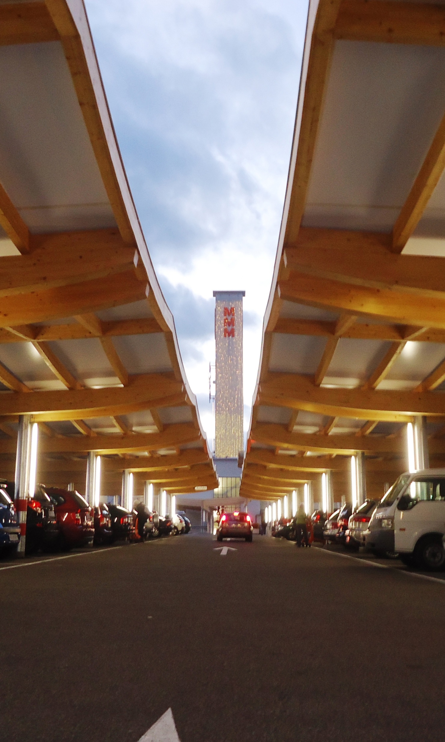Photograph taken amid the car parking with wooden roofing at the Ladedorf shopping centre