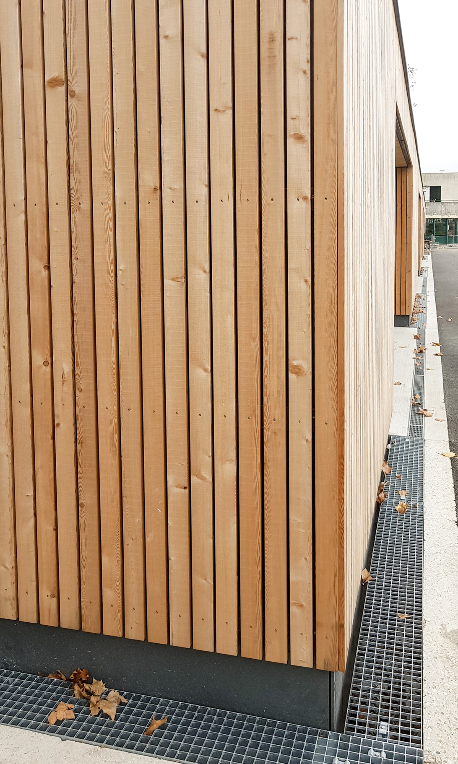 Corner with timber facade on the single-storey extension building with changing rooms