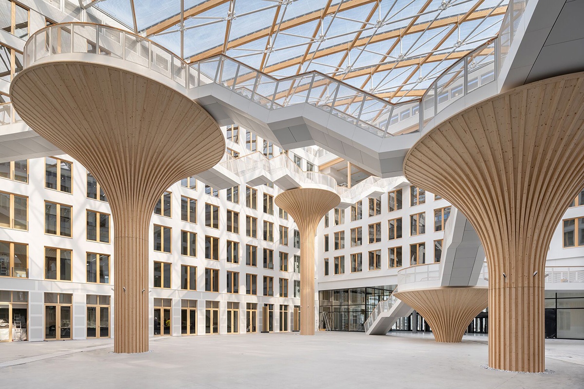Tree structures of varying heights in the atrium of the EDGE office building in Berlin