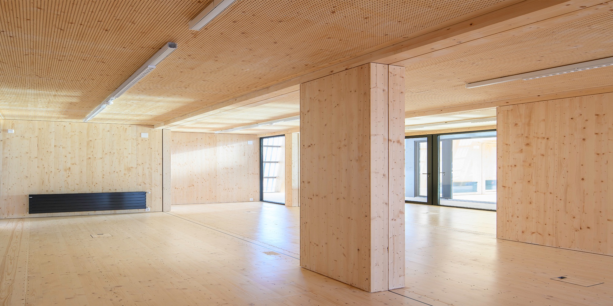 View of an empty room module clad with spruce.