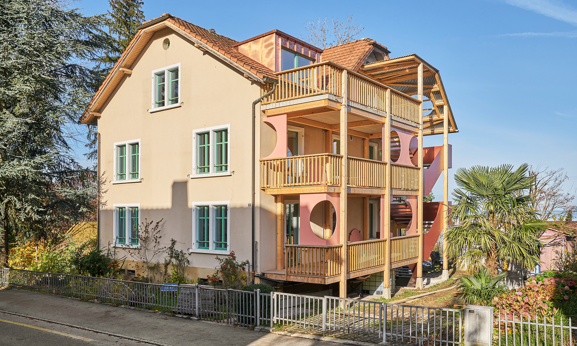 Recycled apartment building with a new external staircase and timber arcades 