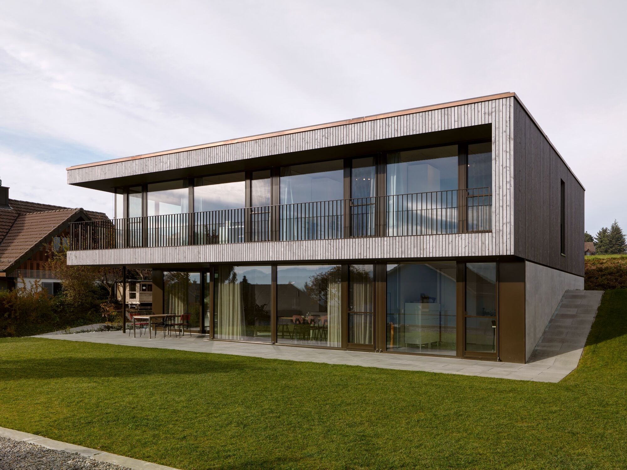 Contemporary detached house with timber facade and glass frontage