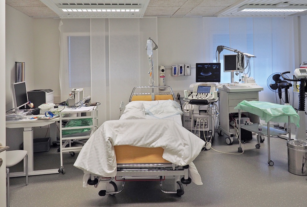 Internal view of a module at the St. Claraspital temporary hospital. The module is equipped as a treatment room with nursing bed, ultrasonic device, desk and various other medical devices.