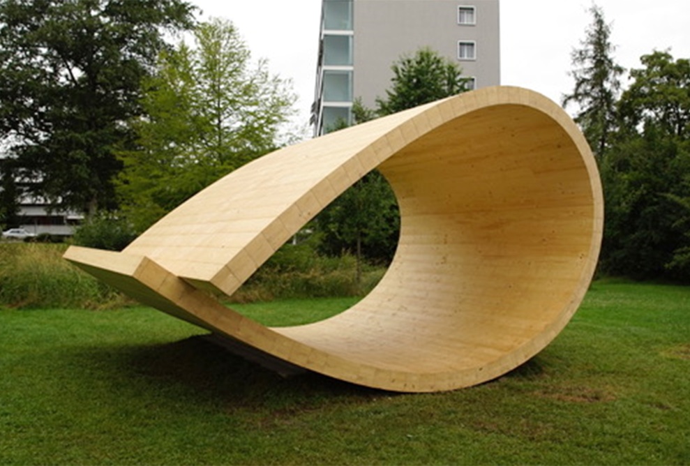 The sound pavilion in the park. An apartment building can be seen in the background.