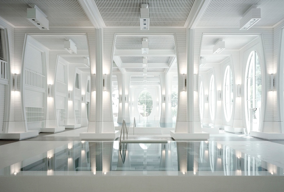 Interior view of the Tamina Therme; pool with white columns, illuminated