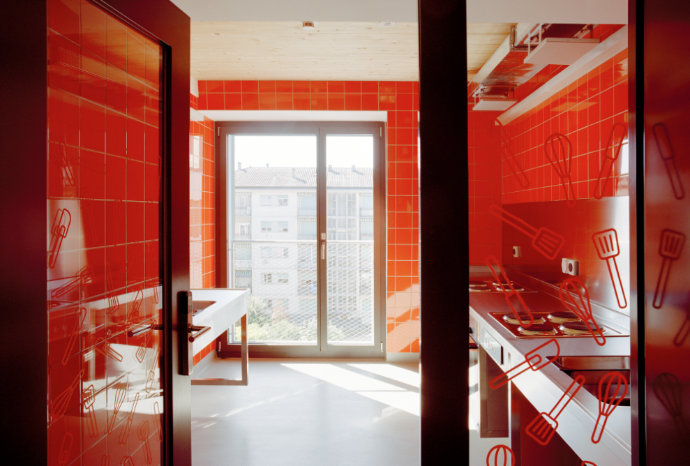 View into the kitchen with red wall panelling