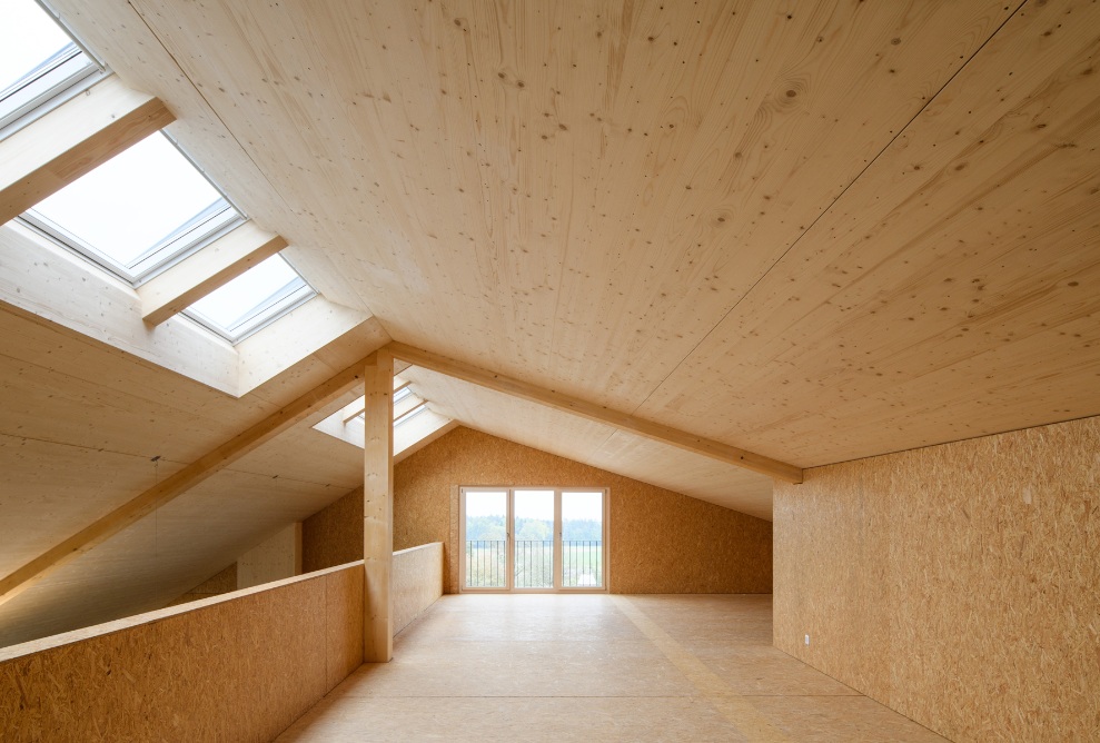 Attic of the new office building fitted out in wood with plenty of natural light.