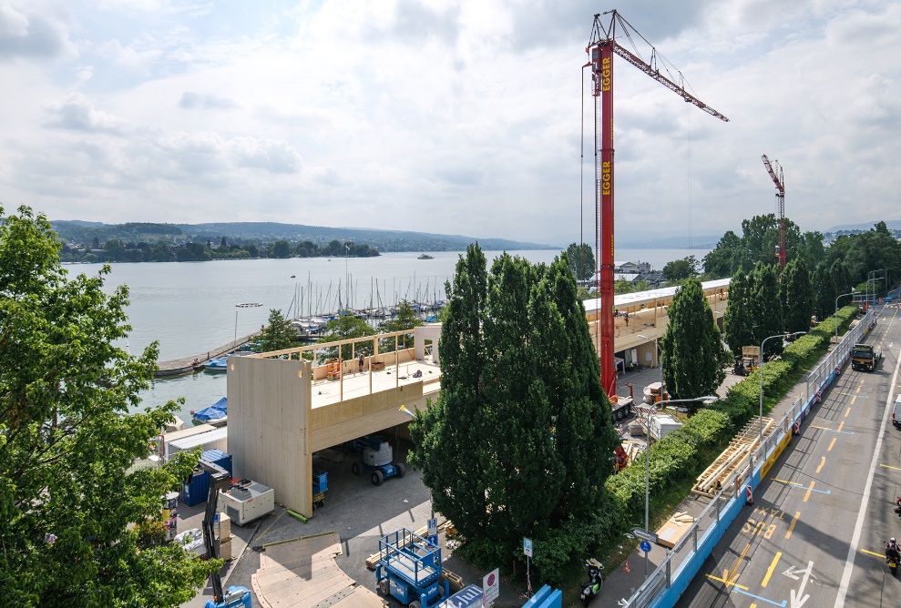 La prise de vue montre l’installation de la formule E à Zurich. En arrière-plan, on voit le lac et l’entrée du port juste derrière le bâtiment événementiel.