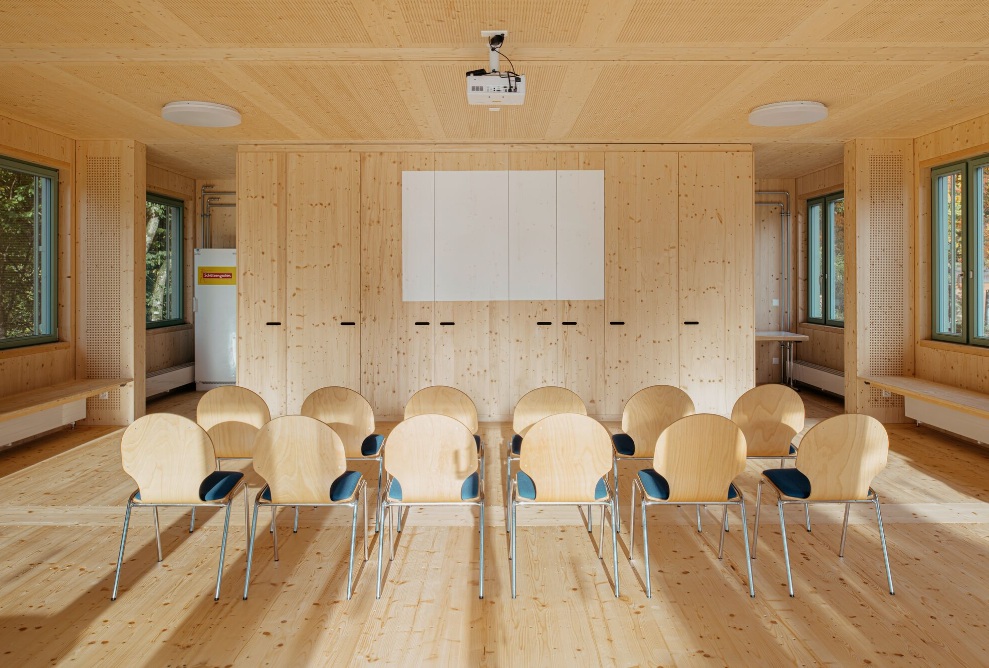 Interior of the Sportfeld pavilion with wooden chairs