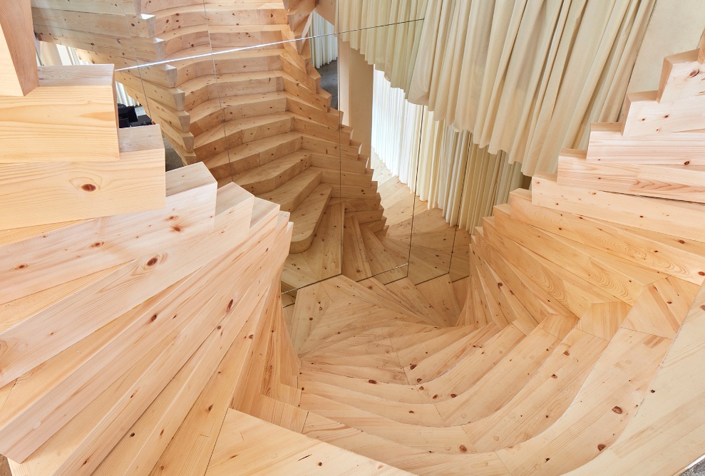 The individual offset wood elements create the steps of the staircase.